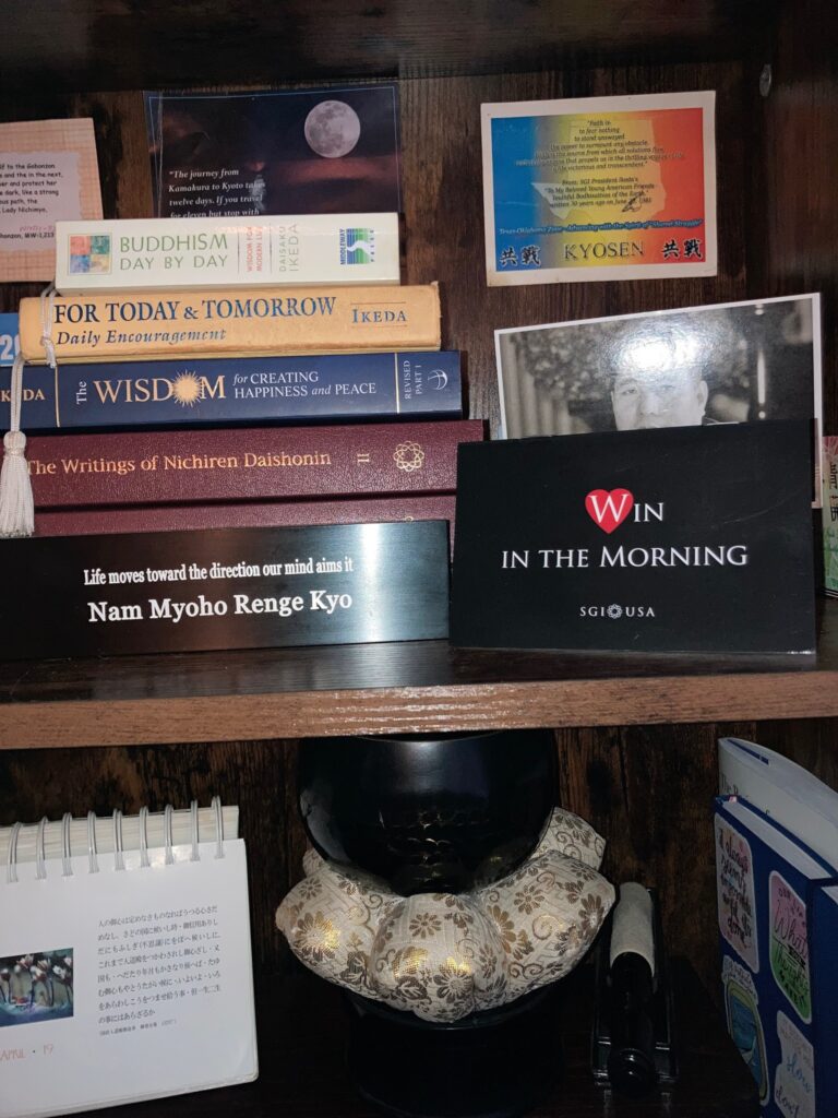 Sunantha Potang's personal Buddhist study space for her "Win in the Morning" practice, featuring a stack of books and journals.